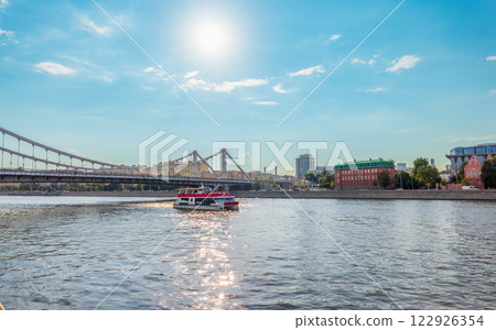 Cruise ship sails on the Moscow river in Moscow city center, popular place for walking. 122926354