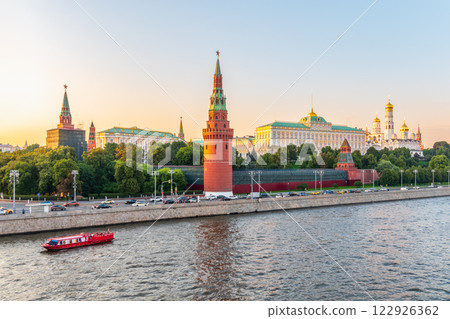 View of Kremlin with Vodovzvodnaya tower, Grand Kremlin Palace from repaired Bolshoy Kamenny Bridge in Moscow city on sunny summer day. Cruise ship sails on the Moscow river View of Kremlin with Vodovzvodnaya tower, Grand Kremlin Palace from repaired Bolshoy Kamenny Bridge in Moscow city on sunny summer day. Cruise ship sails on the Moscow river 122926362