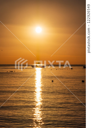 Beautiful red and orange sunrise over the sea. Beautiful red and orange sunrise over the sea. 122926549