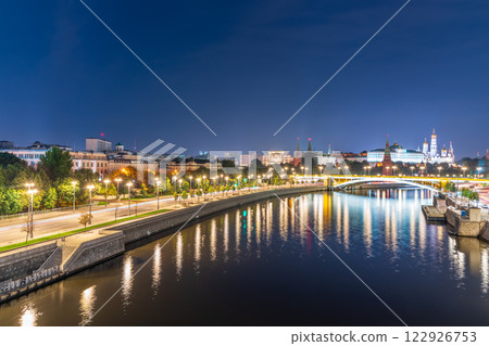 Illuminated Moscow Kremlin and Bolshoy Kamenny Bridge at summer night. View from the Patriarshy pedestrian Bridge 122926753