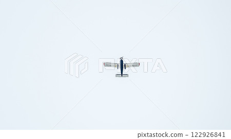 Small ultralight airplane with overhead wing and single propeller flying in sunset sky. 122926841