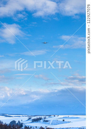 An airplane flying through the winter skies of Hokkaido An airplane flying through the winter skies of Hokkaido 122927076