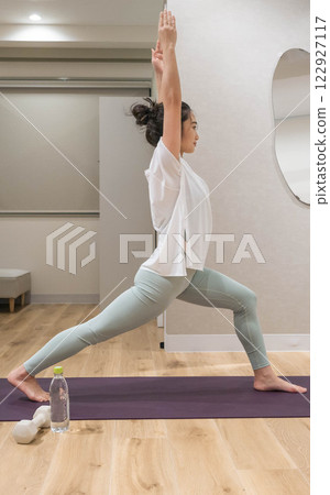 woman doing yoga indoors 122927117