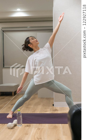 woman doing yoga indoors 122927118