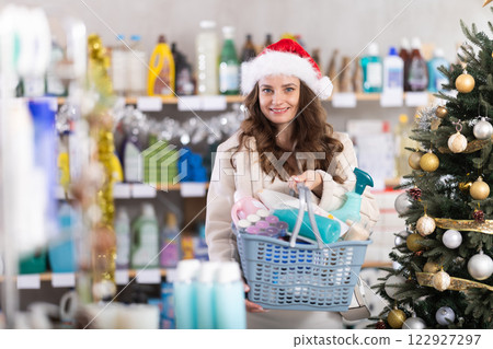 Young woman chooses household chemicals in decorated store 122927297