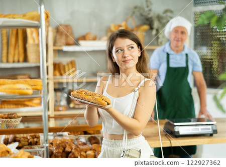 Young woman buyer with bocadillo in bakery Young woman buyer with bocadillo in bakery 122927362