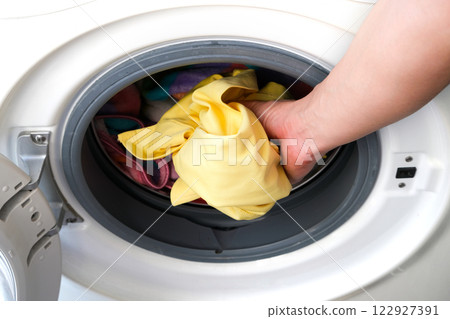 Woman's hand Pick up clothes Washing machine.Clean and Healthy Concepts. Woman's hand Pick up clothes Washing machine.Clean and Healthy Concepts. 122927391