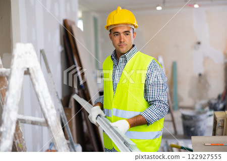 Repairman working in construction site in apartment 122927555