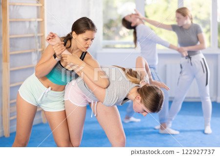 Pair self defense training - two teenage girls doing power grabs Pair self defense training - two teenage girls doing power grabs 122927737