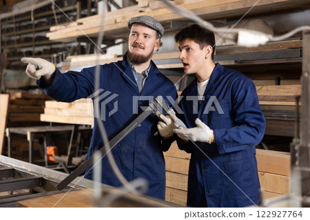 Foreman gives instructions to worker at furniture factory Foreman gives instructions to worker at furniture factory 122927764