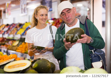 Father and his teenage daughter doing grocery shopping 122927917