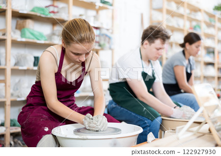 Girl teenager learns how to create pottery in workshop 122927930