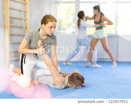 Pair self defense training - two teenage girls doing power grabs 122927951