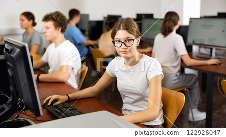Portrait of positive smart girl in computer class 122928047