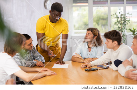 Group of men discussing something at the desk Group of men discussing something at the desk 122928162
