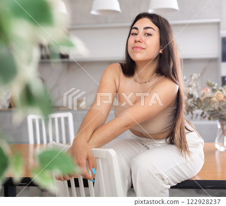Young smiling woman posing in kitchen at home 122928237