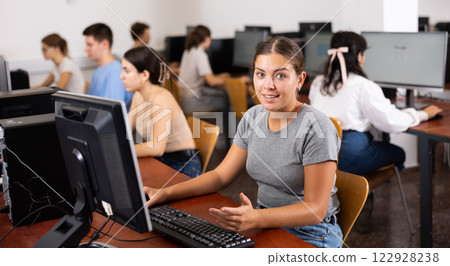 Teacher works at computer in the classroom. Students doing programming 122928238
