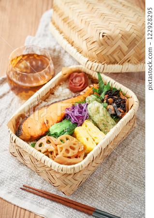 Grilled salmon bento in a bamboo basket – a traditional and colorful Japanese lunch Grilled salmon bento in a bamboo basket – a traditional and colorful Japanese lunch 122928295