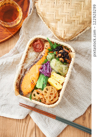 Grilled salmon bento in a bamboo basket – a traditional and colorful Japanese lunch Grilled salmon bento in a bamboo basket – a traditional and colorful Japanese lunch 122928299