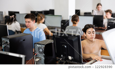 Interested girl student copying notes on copier while studying in computer class 122928390
