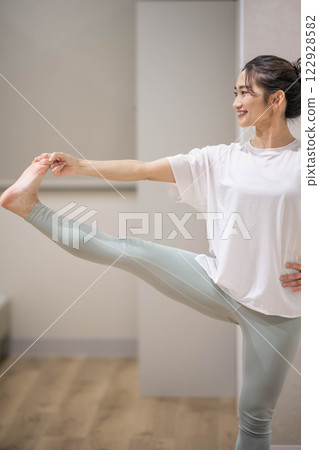 Young woman practicing yoga indoors 122928582