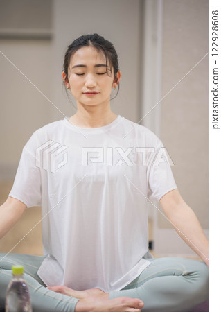 Young woman practicing yoga indoors 122928608