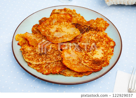 Belarusian potato pancakes draniki with sour cream at plate 122929037