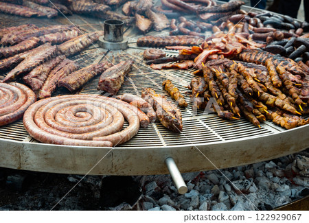 Different types of sausages and meat on grill 122929067