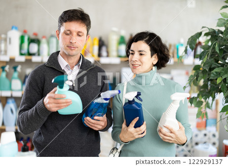 Husband and wife choose a spray for surfaces Husband and wife choose a spray for surfaces 122929137