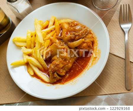 Pig's trotter served on white plate 122929168