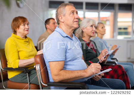 Group of mature students attending lecture in college 122929292