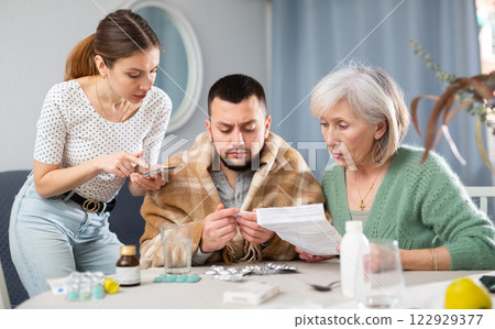 Family taking care of sick man at home 122929377