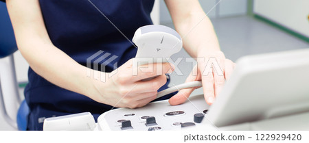 doctor sitting in office in a hospital doing ultrasound scanning diagnostic 122929420