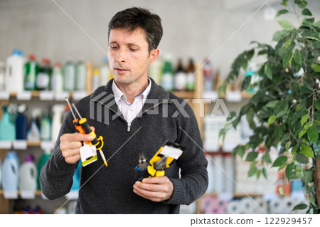 Adult man holding tools in his hands Adult man holding tools in his hands 122929457