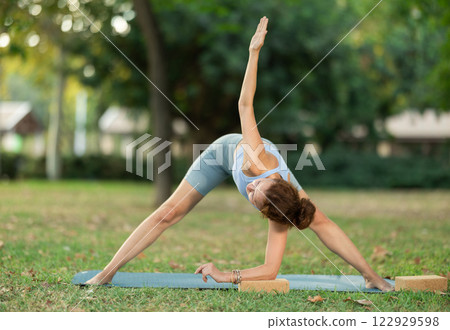 Adult woman doing yoga with blocks 122929598