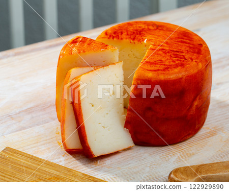 Tasty french goat cheese with pepper, slices at wooden desk 122929890