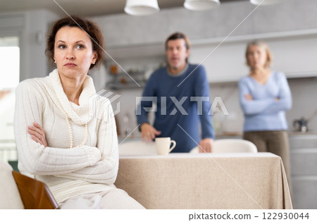 Man and mature mom yell to woman Man and mature mom yell to woman 122930044