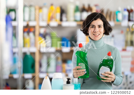Middle-aged woman choosing dishwashing liquid at department store 122930052