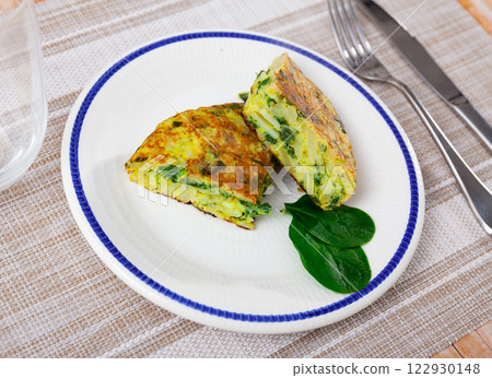 Spinach omelette served for breakfast on platter 122930148