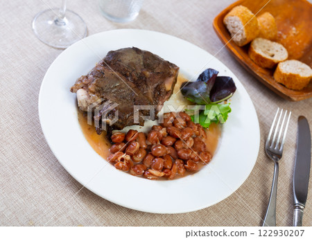 Baked pork cheek with stewed pinto beans and greens Baked pork cheek with stewed pinto beans and greens 122930207