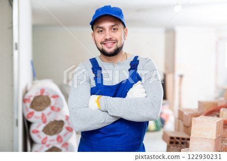 Positive foreman posing on indoor construction site 122930231