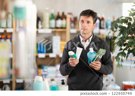 man buys toothbrushes in a store 122930749