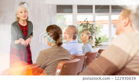 Mature woman coach teaches seniors in refresher courses Mature woman coach teaches seniors in refresher courses 122930839