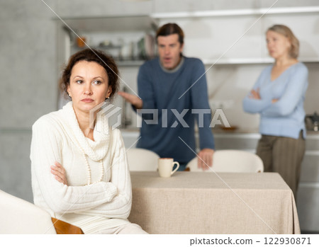 Man and mature mom yell to woman Man and mature mom yell to woman 122930871