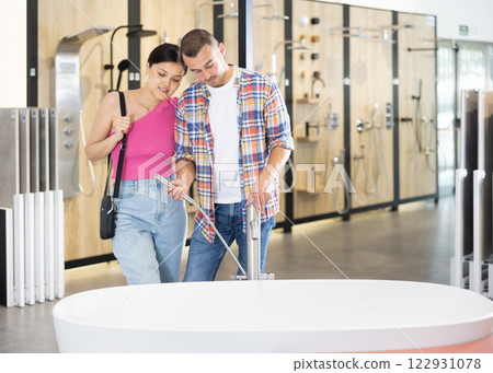 Couple man and woman choosing bath in hardware store 122931078