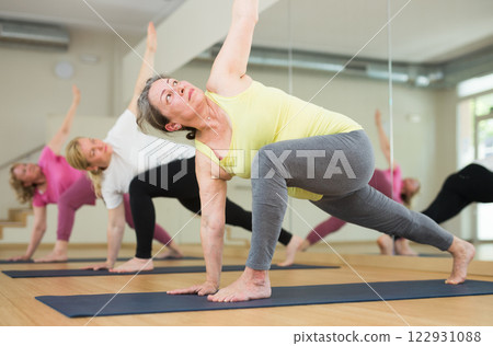 Three women are doing angle pose Three women are doing angle pose 122931088