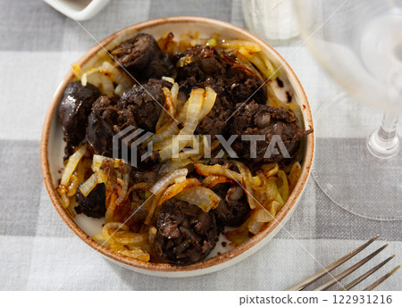 Delicious fried morcilla (blood sausage with rice) and grilled onion served on plate Delicious fried morcilla (blood sausage with rice) and grilled onion served on plate 122931216