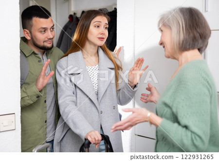 Couple saying goodbye to elderly mother Couple saying goodbye to elderly mother 122931265