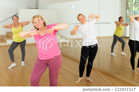 Women are dancing in a fitness room 122931527