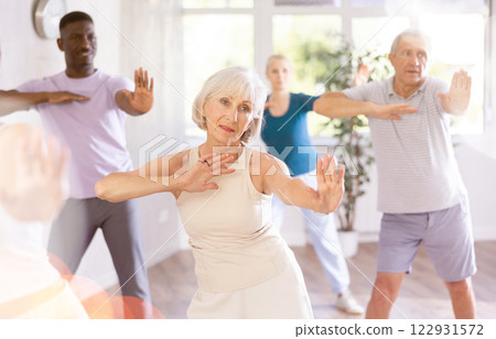 Senior woman dances learn to move energetically to beat of music 122931572